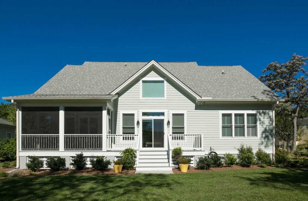 home with white siding for window replacement and repair services